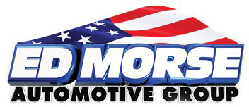 Ed Morse Automotive Group logo with bold text and an American flag waving in the background.